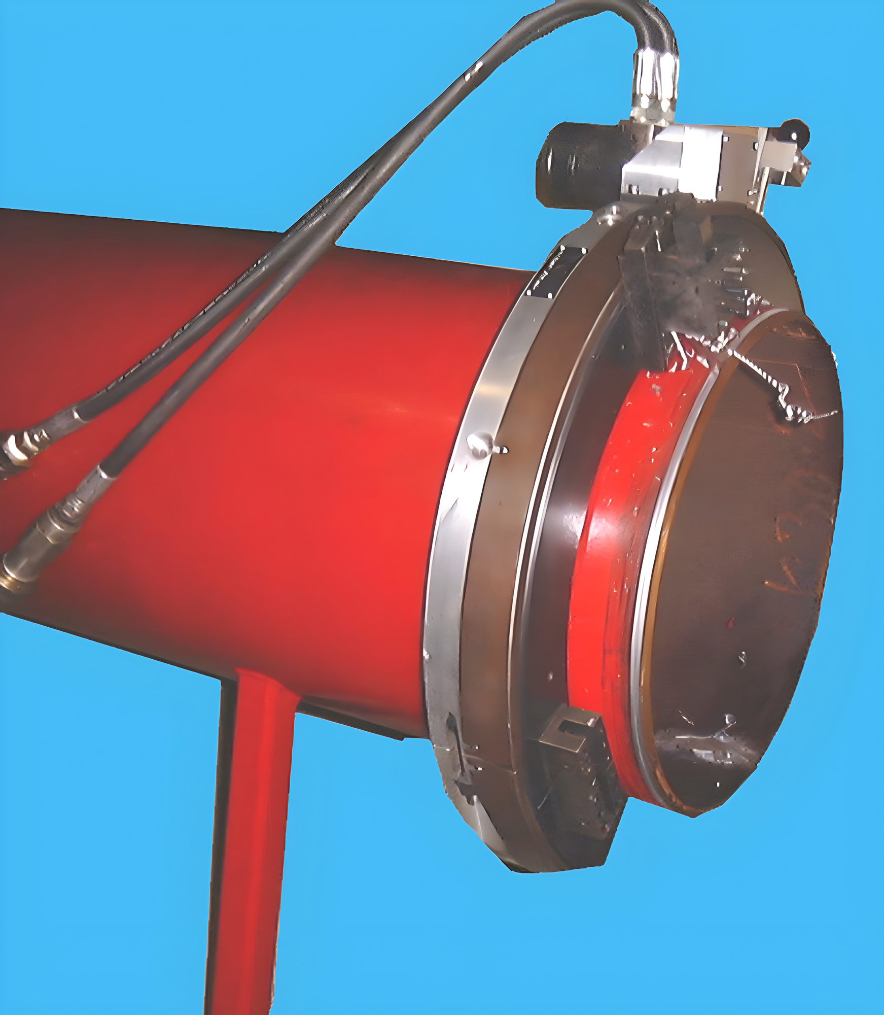 Red Mactech clamshell lathe mounted on a large pipe